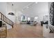 Bright living room featuring hardwood floors, large windows, and staircase at 6435 E Monte Cristo Ave, Scottsdale, AZ 85254