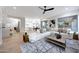 Bright living room with a large white sectional sofa, wood floors and views into the kitchen at 6435 E Monte Cristo Ave, Scottsdale, AZ 85254