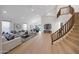 Spacious living room with an elegant staircase, modern decor, and an open floor plan connecting to the dining area at 6435 E Monte Cristo Ave, Scottsdale, AZ 85254