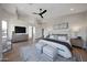 This main bedroom has hardwood floors, a sitting area, large TV, and an attached bath at 6435 E Monte Cristo Ave, Scottsdale, AZ 85254