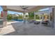 Inviting outdoor living space with a covered patio, ceiling fan, a fire pit, comfortable seating and a sparkling pool at 6435 E Monte Cristo Ave, Scottsdale, AZ 85254