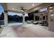 Covered patio with a fan overlooks the beautiful pool and outdoor living space with a fire pit at 6435 E Monte Cristo Ave, Scottsdale, AZ 85254