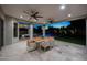 Spacious covered patio featuring travertine tile, ceiling fans, and outdoor dining area, perfect for entertaining by the pool at 6435 E Monte Cristo Ave, Scottsdale, AZ 85254