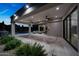 Expansive covered patio with travertine tile, ceiling fans, and outdoor seating area, overlooking the pool and landscaped backyard at 6435 E Monte Cristo Ave, Scottsdale, AZ 85254
