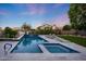 Beautiful pool and spa surrounded by lush landscaping and travertine tile, perfect for enjoying the outdoors at 6435 E Monte Cristo Ave, Scottsdale, AZ 85254
