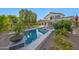 A sparkling pool and spa are surrounded by lush landscaping in this home's backyard oasis, complete with covered patio at 6435 E Monte Cristo Ave, Scottsdale, AZ 85254