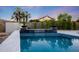 Tranquil pool area featuring a waterfall feature, lush landscaping, and elegant tile work creates a resort-like ambiance at 6435 E Monte Cristo Ave, Scottsdale, AZ 85254