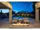 Backyard with a well-lit pool, hot tub, lounge chairs, and an outdoor dining area, perfect for relaxation and entertainment at 6435 E Monte Cristo Ave, Scottsdale, AZ 85254