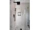 Modern shower stall featuring white marble tiles and black shower head and fixtures at 6435 E Monte Cristo Ave, Scottsdale, AZ 85254