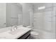 Bright bathroom with tub shower combination, tile surround, and vanity at 663 W Flintlock Way, Chandler, AZ 85286