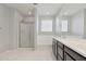 Bathroom with glass shower, soaking tub, and dark wood vanity cabinets at 663 W Flintlock Way, Chandler, AZ 85286