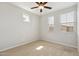 Minimalist carpeted bedroom with a ceiling fan and multiple bright windows at 663 W Flintlock Way, Chandler, AZ 85286