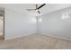 Bright bedroom featuring plush neutral carpet and a ceiling fan at 663 W Flintlock Way, Chandler, AZ 85286