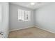 Bright bedroom with neutral carpet and a large window with blinds at 663 W Flintlock Way, Chandler, AZ 85286