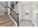 Bright entryway features wood-look tile floors, staircase, and a glass-paneled front door leading to the backyard at 663 W Flintlock Way, Chandler, AZ 85286