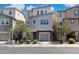 Contemporary two-story home featuring mixed siding, a gray garage door, and neat landscaping at 663 W Flintlock Way, Chandler, AZ 85286