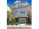 Modern two-story home with neutral siding, brick accents, a gray garage door, and well-maintained landscaping at 663 W Flintlock Way, Chandler, AZ 85286