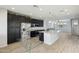 Open kitchen with large island, granite countertops, stainless steel appliances, and dark cabinetry at 663 W Flintlock Way, Chandler, AZ 85286