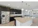 Bright, open kitchen with a large island, granite countertops, stainless steel appliances, and a view to the living area at 663 W Flintlock Way, Chandler, AZ 85286