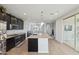 Bright, open kitchen with stainless steel appliances, granite countertops, and center island at 663 W Flintlock Way, Chandler, AZ 85286
