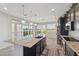 Open kitchen layout with a large island, stainless steel appliances, and sliding doors leading to the patio at 663 W Flintlock Way, Chandler, AZ 85286