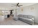 Open-concept living room featuring wood-style floors and a comfortable gray sofa at 663 W Flintlock Way, Chandler, AZ 85286