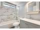 This bathroom features a bathtub with white marble tiled wall and vanity with white countertop at 6804 W Turquoise Ave, Peoria, AZ 85345