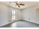 This bedroom includes a ceiling fan and natural light from the window at 6804 W Turquoise Ave, Peoria, AZ 85345