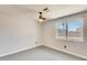 This bedroom features a ceiling fan, and natural light from the window at 6804 W Turquoise Ave, Peoria, AZ 85345