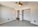 This bedroom features a ceiling fan, closet, and view to the hallway at 6804 W Turquoise Ave, Peoria, AZ 85345