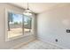 A dining room featuring a large window that offers backyard views and patterned flooring at 6804 W Turquoise Ave, Peoria, AZ 85345