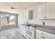 This kitchen features white cabinets and a view to the backyard at 6804 W Turquoise Ave, Peoria, AZ 85345