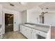 The kitchen features white cabinets and provides a view into the expansive living room at 6804 W Turquoise Ave, Peoria, AZ 85345