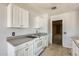 This kitchen features white cabinets and an electric range oven at 6804 W Turquoise Ave, Peoria, AZ 85345