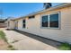 Back exterior of home featuring large windows, a door, and a concrete patio at 6804 W Turquoise Ave, Peoria, AZ 85345