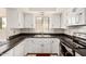 Updated kitchen with white cabinetry and black countertops at 7061 E Broadway Rd # 48, Mesa, AZ 85208