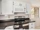Bright kitchen features white cabinets, dark countertops, and stainless steel appliances at 7061 E Broadway Rd # 48, Mesa, AZ 85208