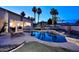 Backyard with pool featuring a waterfall, palm trees, lounge area and covered patio with dining at 8026 W Villa Lindo Dr, Peoria, AZ 85383