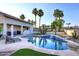 Gorgeous backyard features a sparkling pool with rock accents and artificial turf, perfect for relaxation at 8026 W Villa Lindo Dr, Peoria, AZ 85383