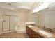 Bright bathroom featuring double sinks, granite countertops, bathtub, and glass-enclosed shower at 8026 W Villa Lindo Dr, Peoria, AZ 85383