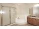 Bathroom featuring a glass-enclosed shower, soaking tub and wood cabinets at 8026 W Villa Lindo Dr, Peoria, AZ 85383