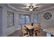 Bright breakfast nook with wood table and chairs, large windows and tile floors at 8026 W Villa Lindo Dr, Peoria, AZ 85383