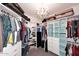 Walk-in closet with custom shelving and a chandelier at 8026 W Villa Lindo Dr, Peoria, AZ 85383