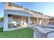 Spacious covered patio with comfortable seating provides shade and overlooks the manicured backyard at 8026 W Villa Lindo Dr, Peoria, AZ 85383