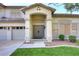 Inviting home front entrance with double doors, manicured lawn, and three car garage at 8026 W Villa Lindo Dr, Peoria, AZ 85383