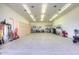 Spacious garage with cabinets and ample lighting, perfect for storage and projects at 8026 W Villa Lindo Dr, Peoria, AZ 85383