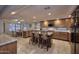 Open kitchen with wooden cabinets, granite countertops, and center island with barstool seating at 8026 W Villa Lindo Dr, Peoria, AZ 85383