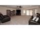 Cozy living room with a large TV, a fireplace, bookcases, and comfortable leather sofas at 8026 W Villa Lindo Dr, Peoria, AZ 85383
