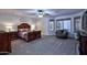 Large bedroom with ceiling fan and cozy seating area at 8026 W Villa Lindo Dr, Peoria, AZ 85383