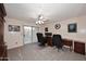 Office with neutral carpet, a ceiling fan, and sliding glass doors to the backyard at 8026 W Villa Lindo Dr, Peoria, AZ 85383
